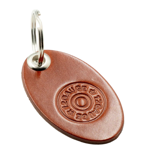 Brown oval keychain tag with a silver ring on a white background