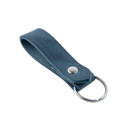 Blue leather keychain with a metal ring on a light gray background